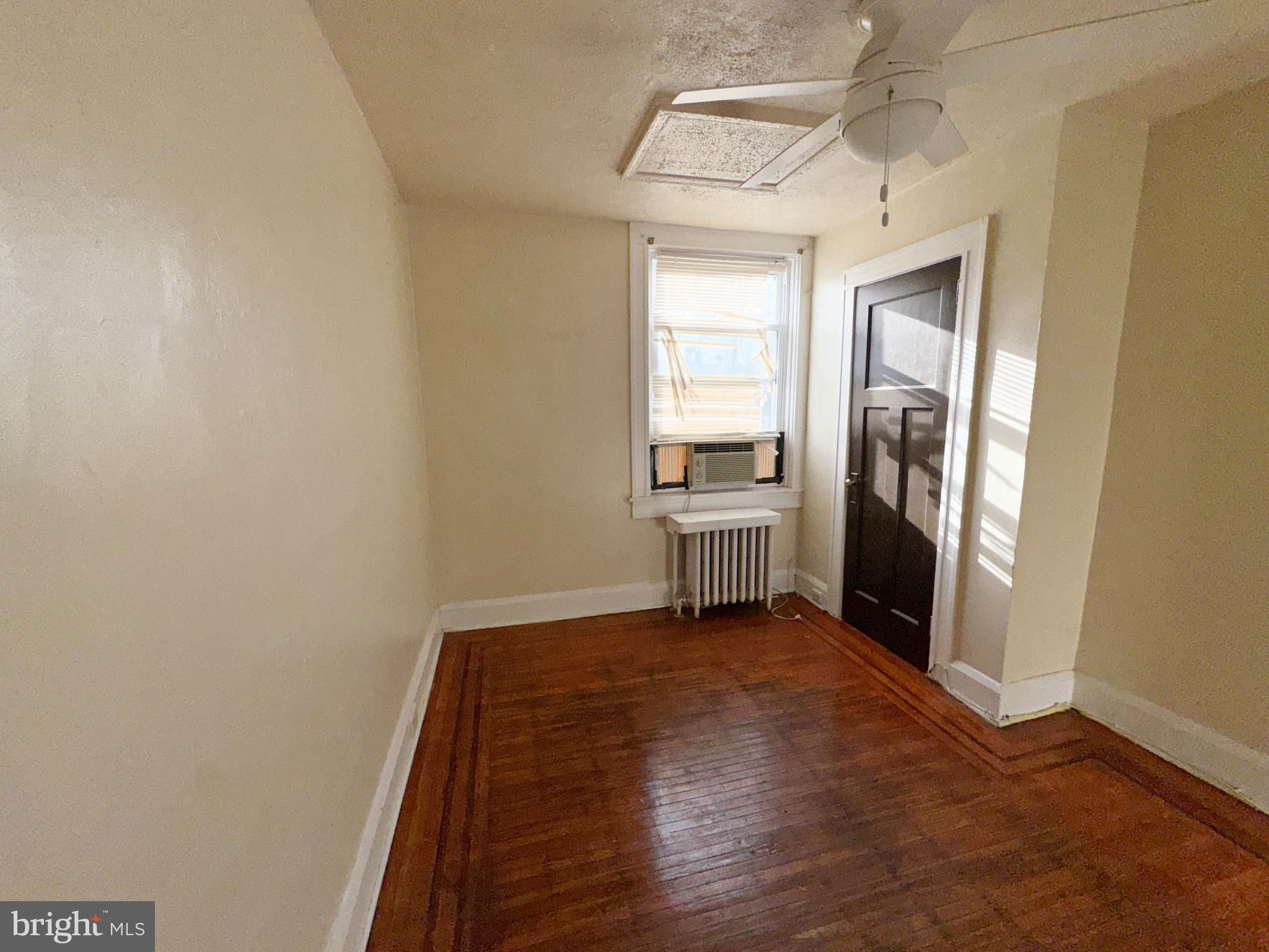 3323 Kenyon Avenue Baltimore, MD 21213 - Photo 17 of 20 a view of a hallway with wooden floor and a cabinet