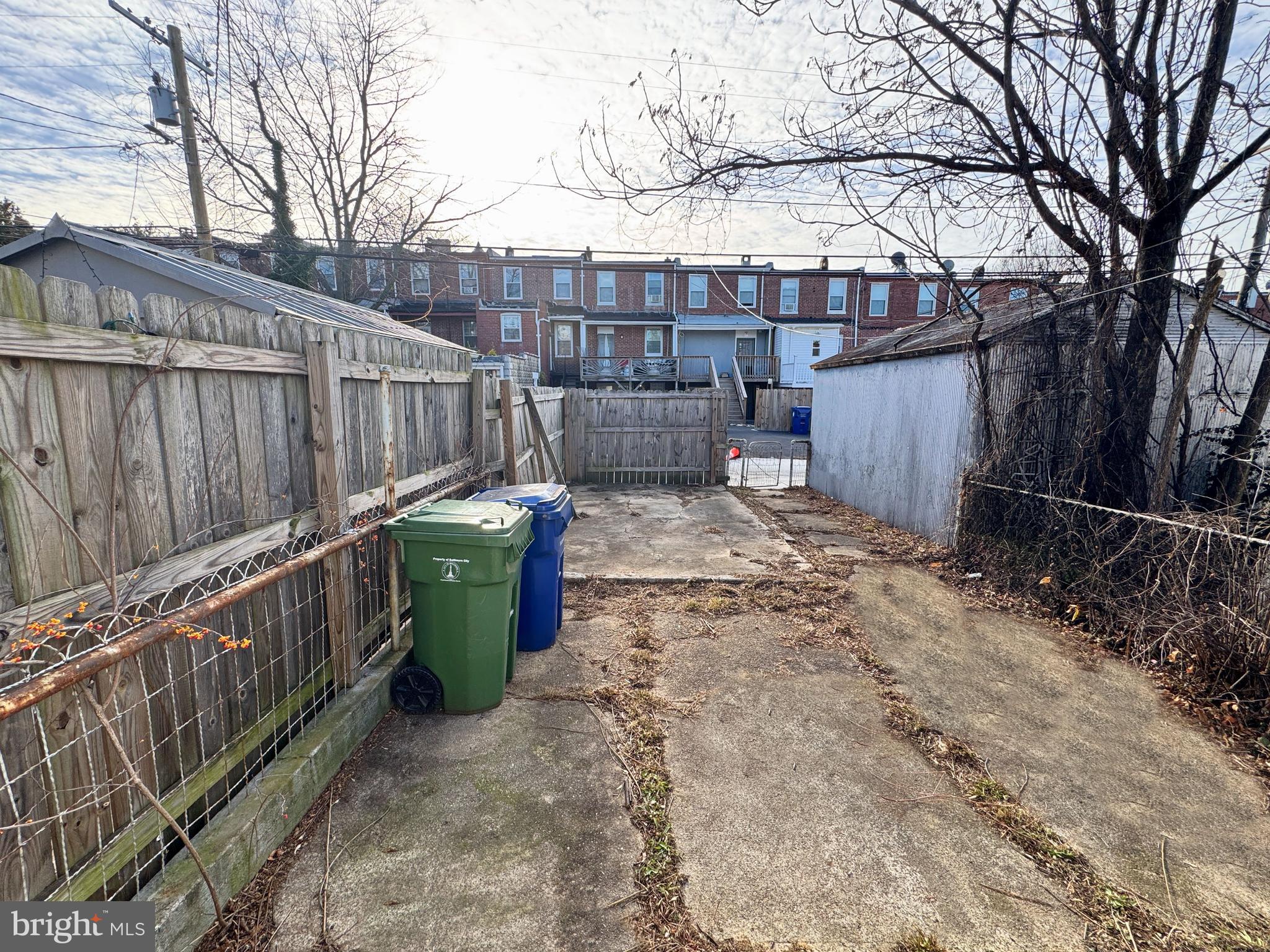 3323 Kenyon Avenue Baltimore, MD 21213 - Photo 4 of 20 a view of a backyard with wooden fence