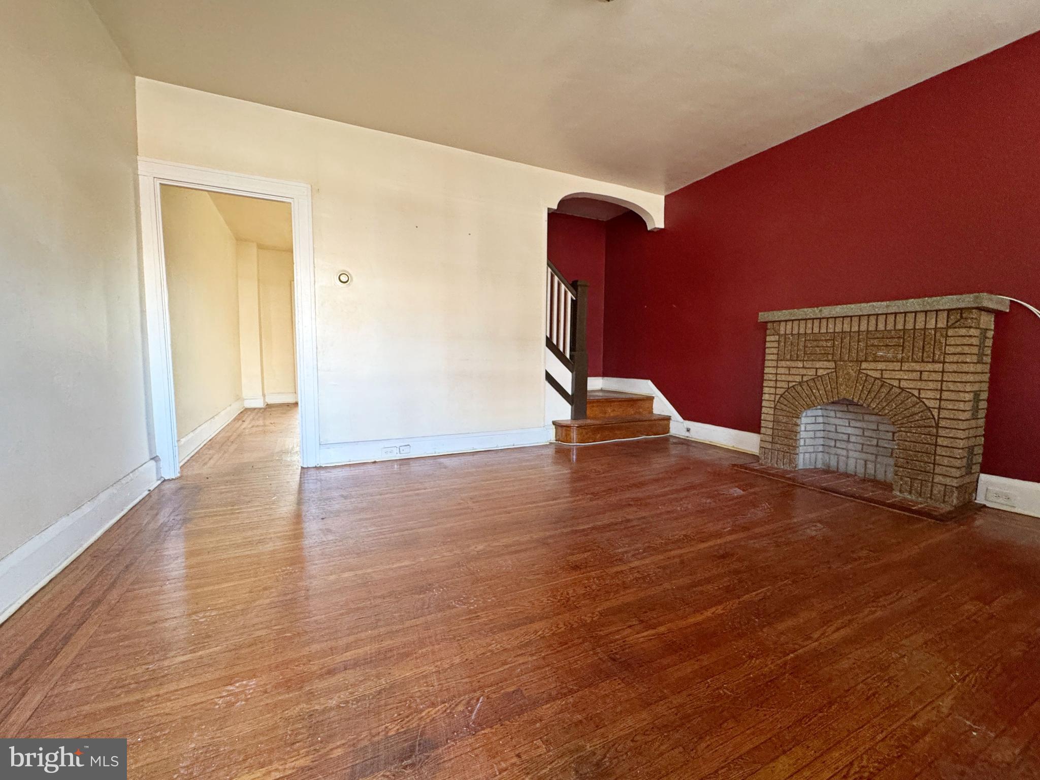3323 Kenyon Avenue Baltimore, MD 21213 - Photo 6 of 20 a view of an empty room with wooden floor
