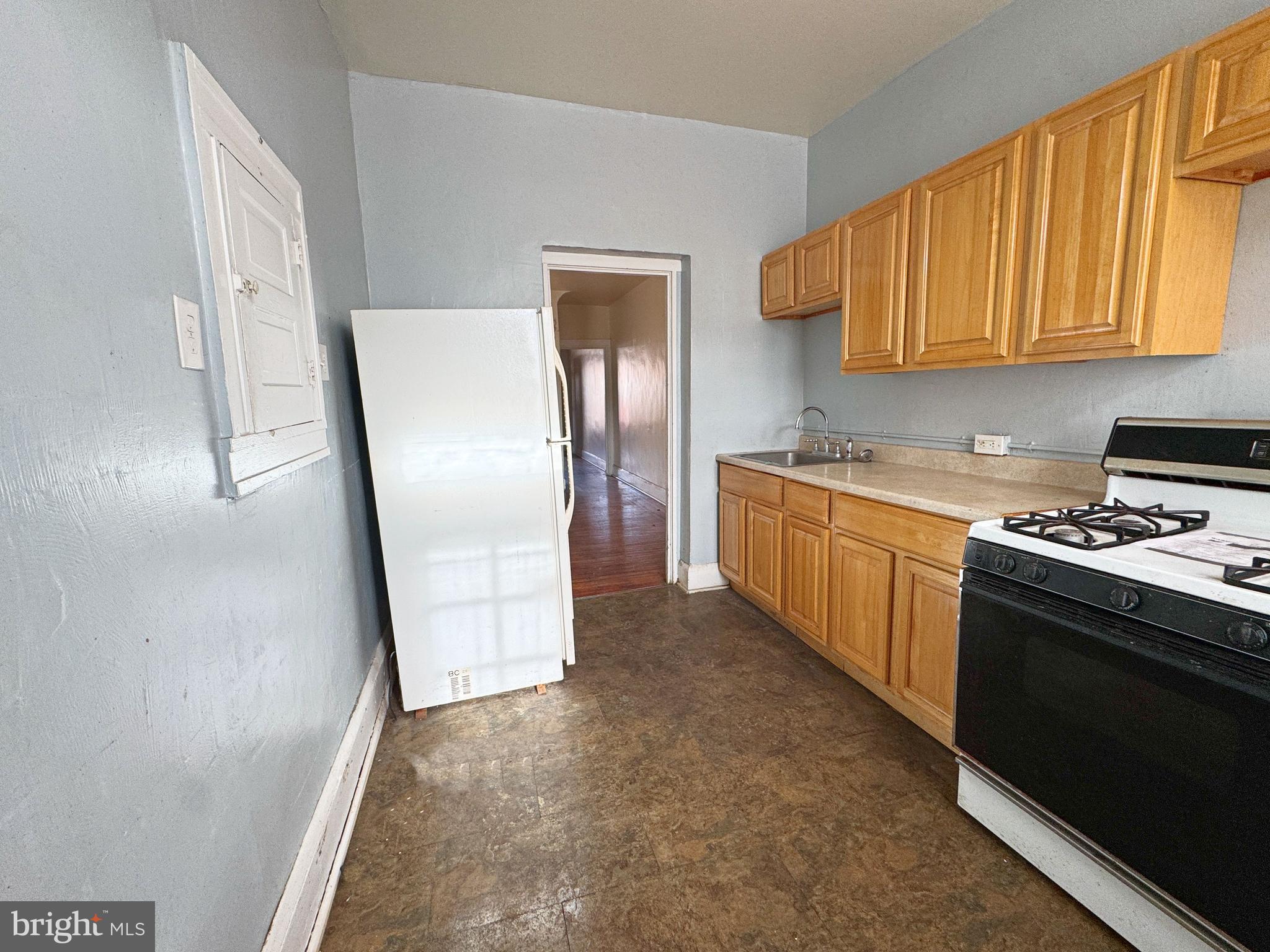 3323 Kenyon Avenue Baltimore, MD 21213 - Photo 9 of 20 a kitchen with stainless steel appliances a refrigerator a stove a sink and a cabinets