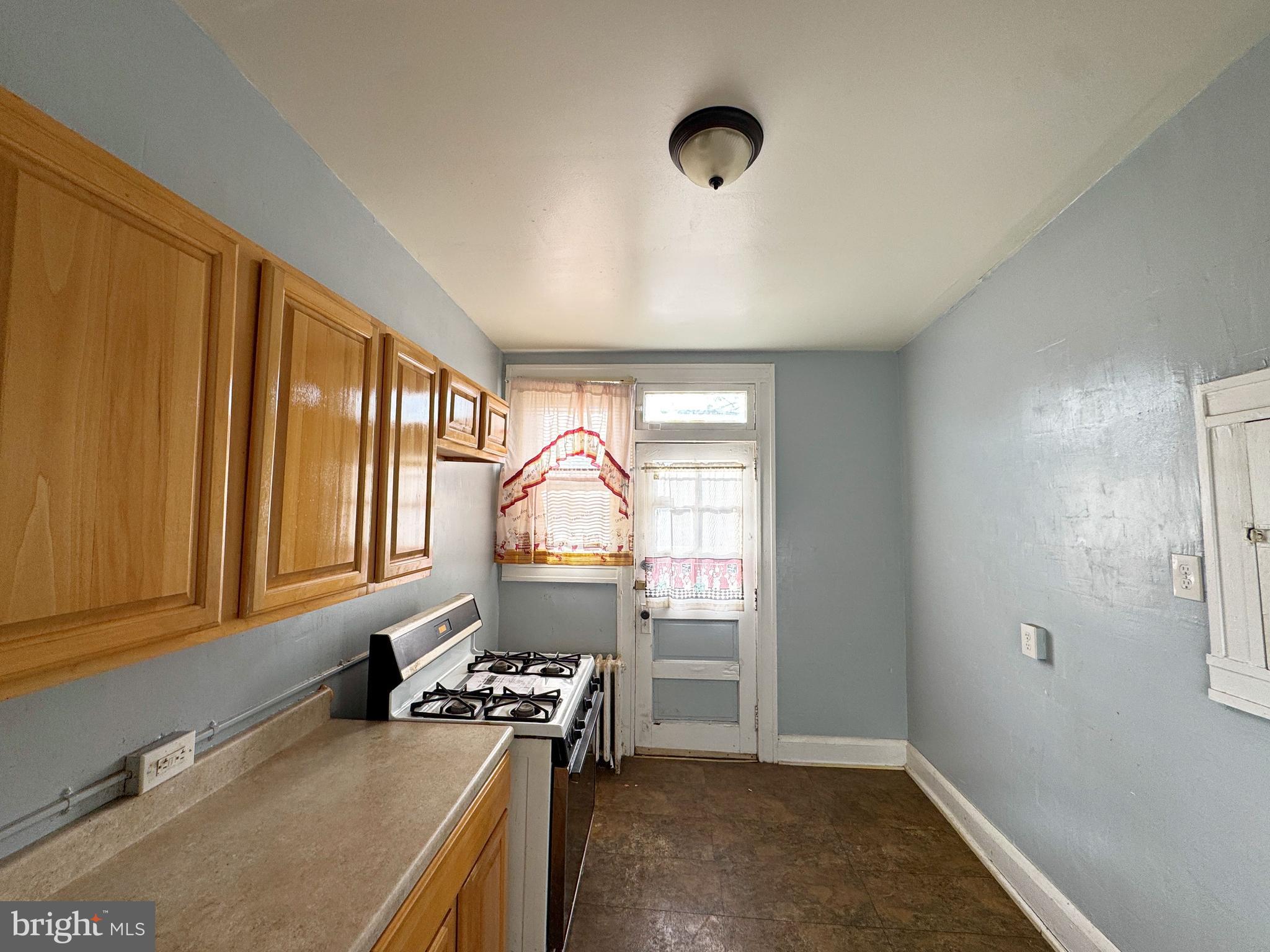 3323 Kenyon Avenue Baltimore, MD 21213 - Photo 10 of 20 a kitchen with a window a sink and a stove