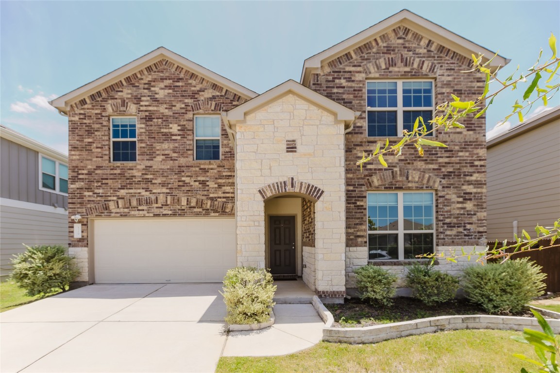 529 Gray Hawk Ridge Leander, TX 78641 - Photo 1 of 36 View of front of property featuring brick siding, an attached garage, concrete driveway, and stone siding