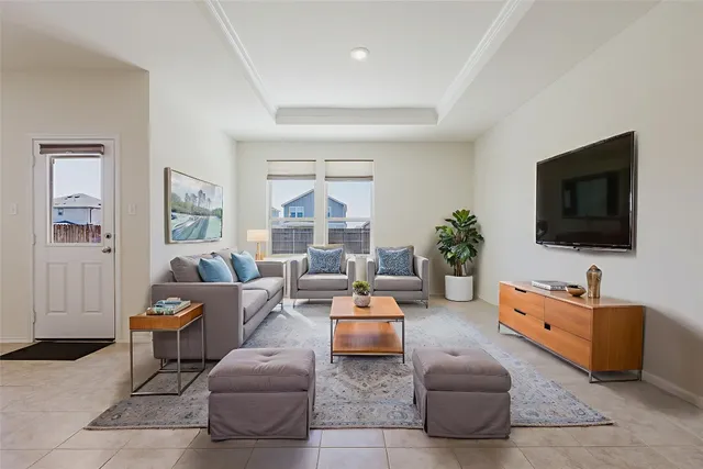 a living room with furniture and a flat screen tv
