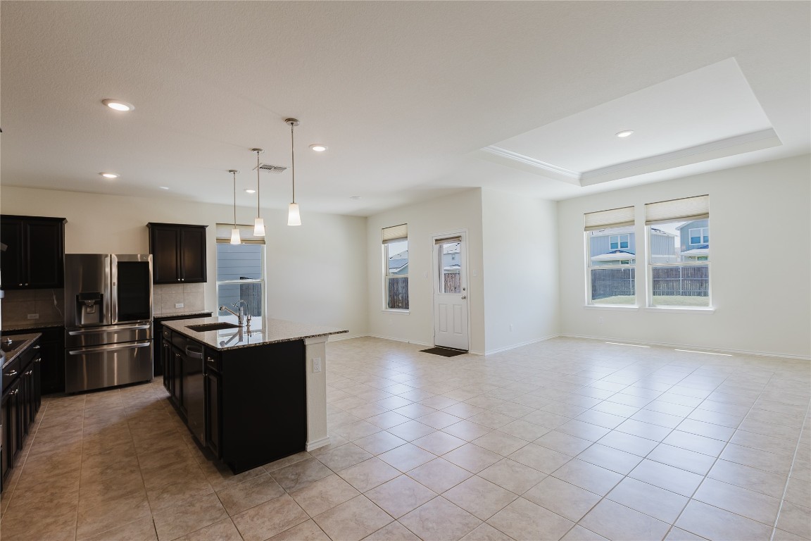 529 Gray Hawk Ridge Leander, TX 78641 - Photo 36 of 36 Kitchen with open floor plan, stainless steel appliances, plenty of natural light, recessed lighting, and light tile patterned floors
