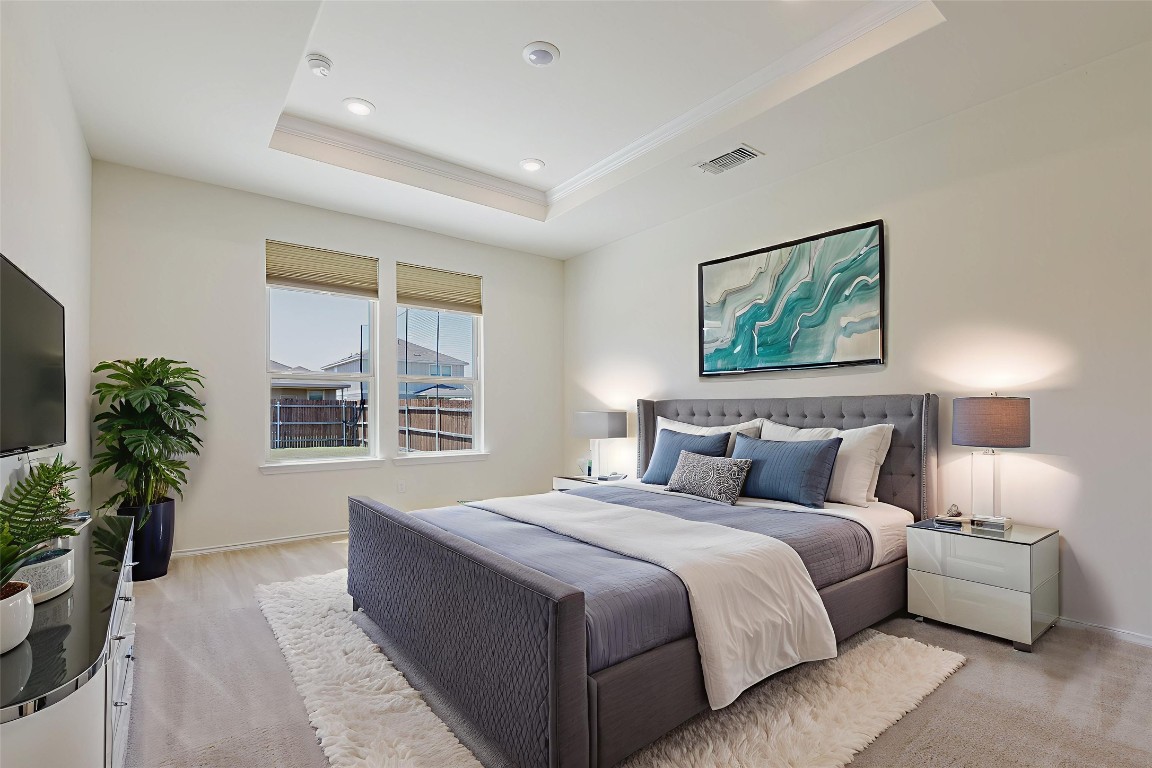529 Gray Hawk Ridge Leander, TX 78641 - Photo 16 of 36 Bedroom featuring crown molding, a tray ceiling, and recessed lighting