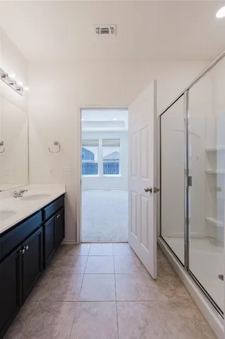 a bathroom with a double vanity sink and mirror