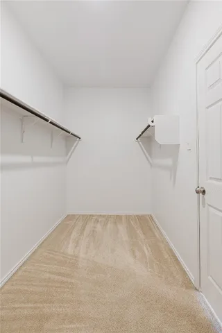 a spacious bathroom with a granite countertop sink a mirror and a shower