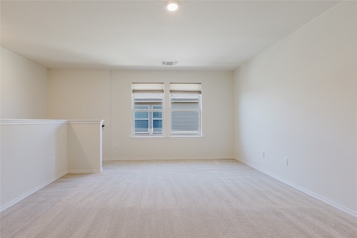 529 Gray Hawk Ridge Leander, TX 78641 - Photo 27 of 36 Unfurnished room with light colored carpet and baseboards