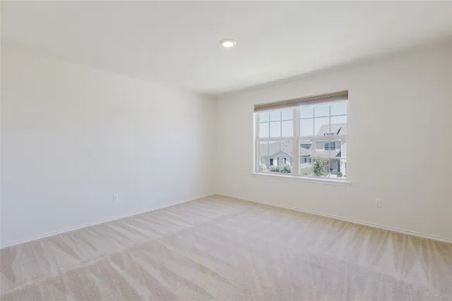 a bedroom with a bed potted plant and window