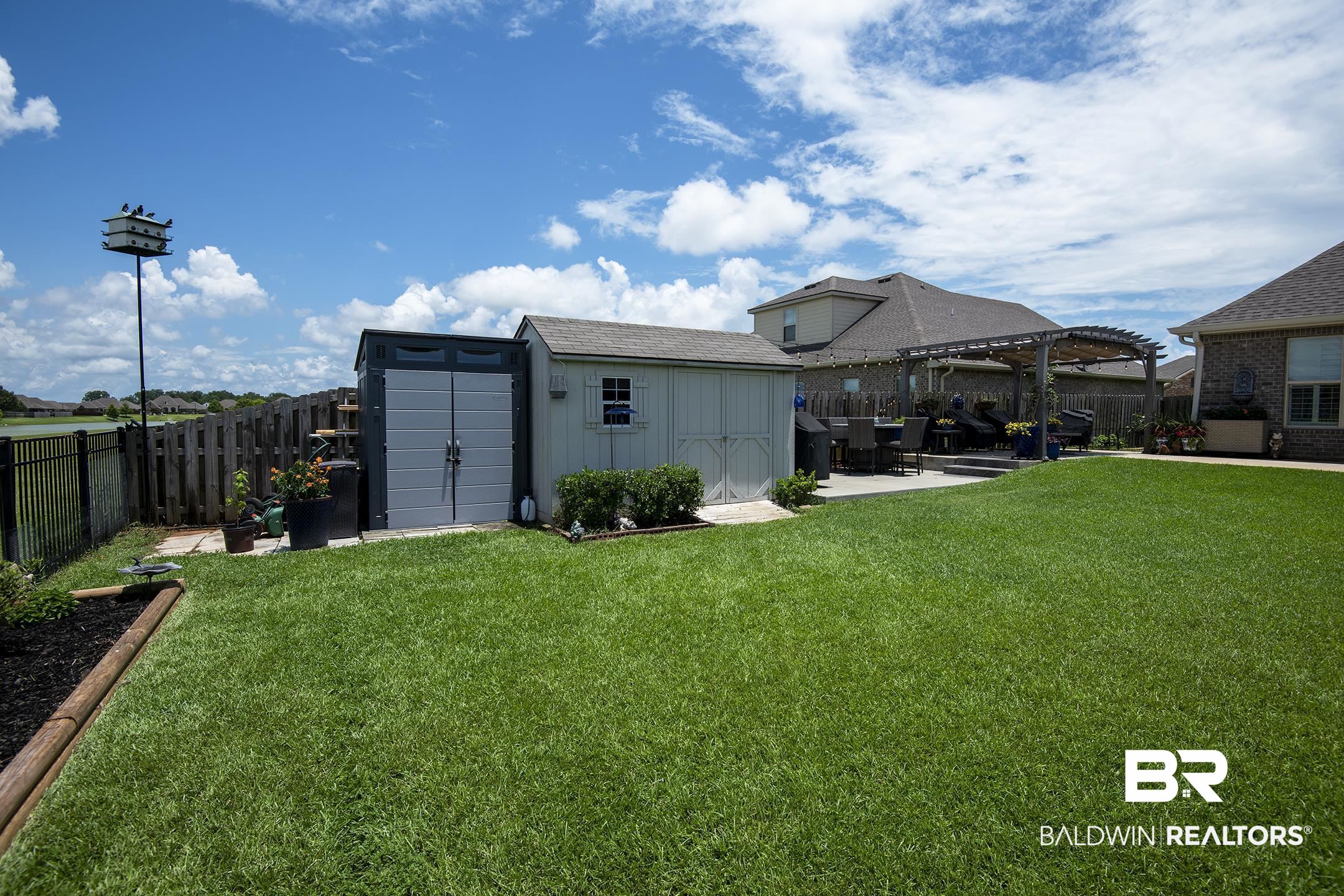 9988 Dunleith Loop Daphne, AL 36526 - Photo 12 of 51 View of yard featuring a storage shed