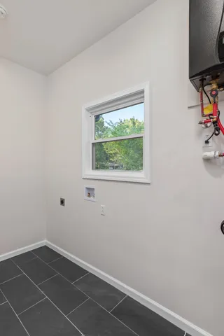 a view of a room with rack on the wall and a window