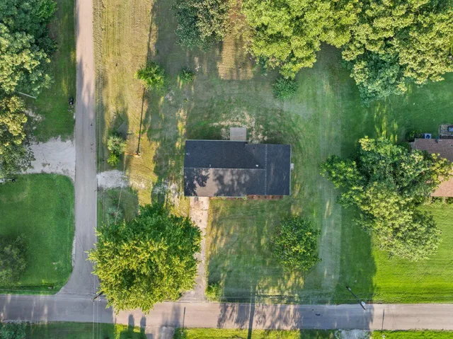 an aerial view of a house with a yard
