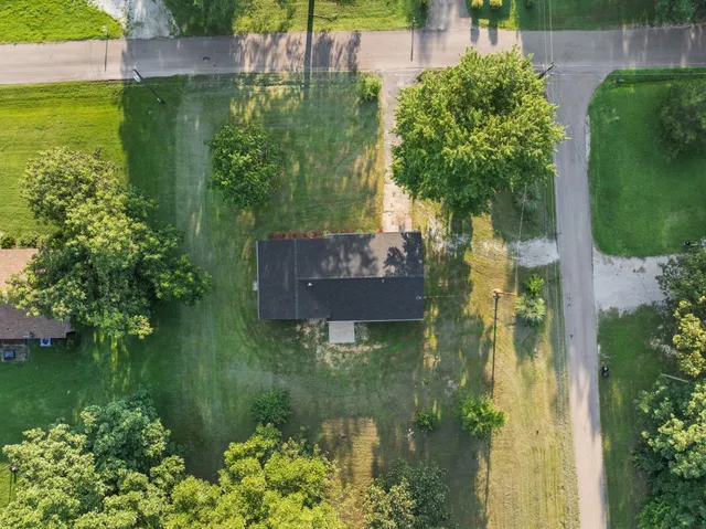 an aerial view of a house with a yard