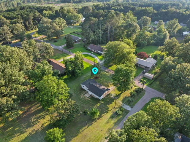 an aerial view of a house with a yard