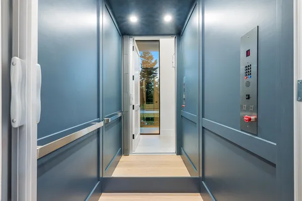 a living room with a large window and ceiling fan