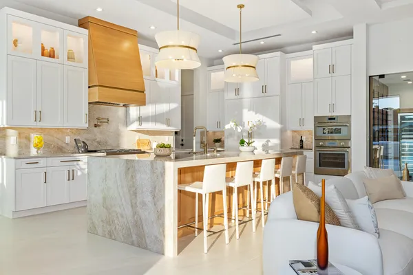 a kitchen with stainless steel appliances kitchen island granite countertop a table and chairs in it