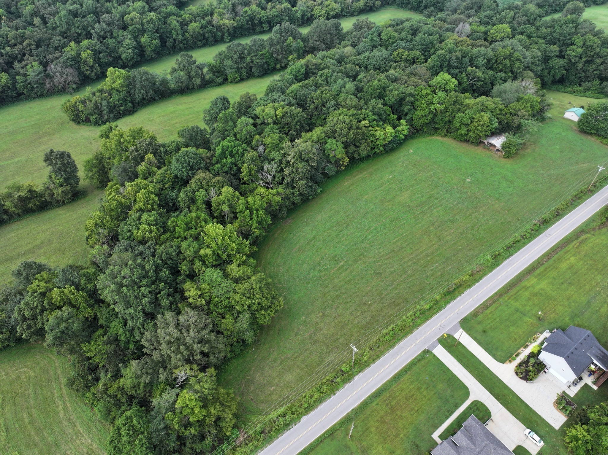 3 Rawlings Road Woodlawn, TN 37191 - Photo 3 of 21 a view of a green yard with a lake