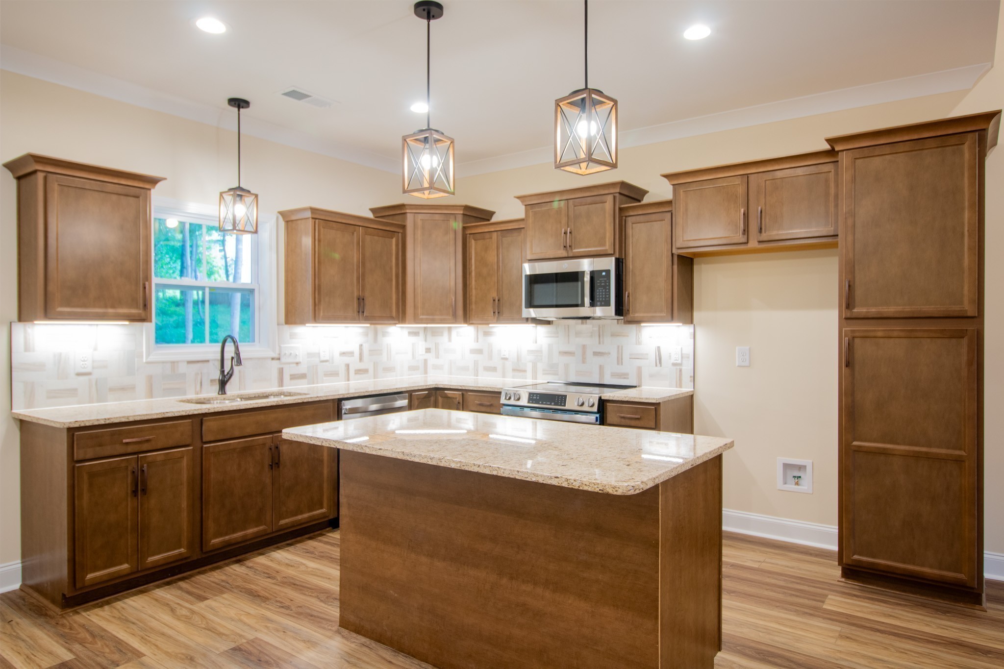 3 Rawlings Road Woodlawn, TN 37191 - Photo 7 of 21 a kitchen with a sink center island and stainless steel appliances