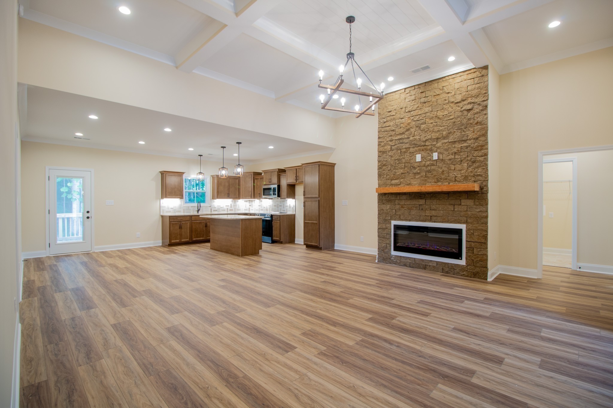 3 Rawlings Road Woodlawn, TN 37191 - Photo 10 of 21 a view of a livingroom with a fireplace a chandelier and wooden floor