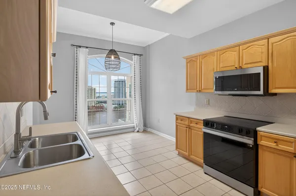 a kitchen with stainless steel appliances granite countertop a refrigerator and a sink