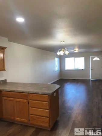 a view of kitchen and hall with wooden floor
