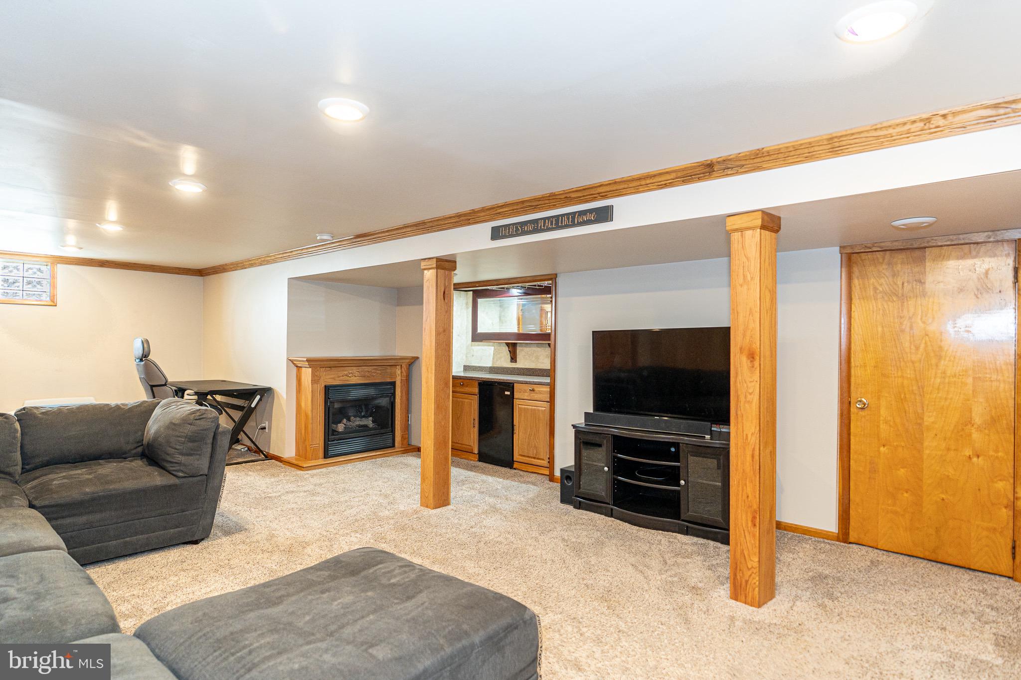 1510 Seling Avenue Rosedale, MD 21237 - Photo 15 of 24 a living room with furniture a flat screen tv and a fireplace