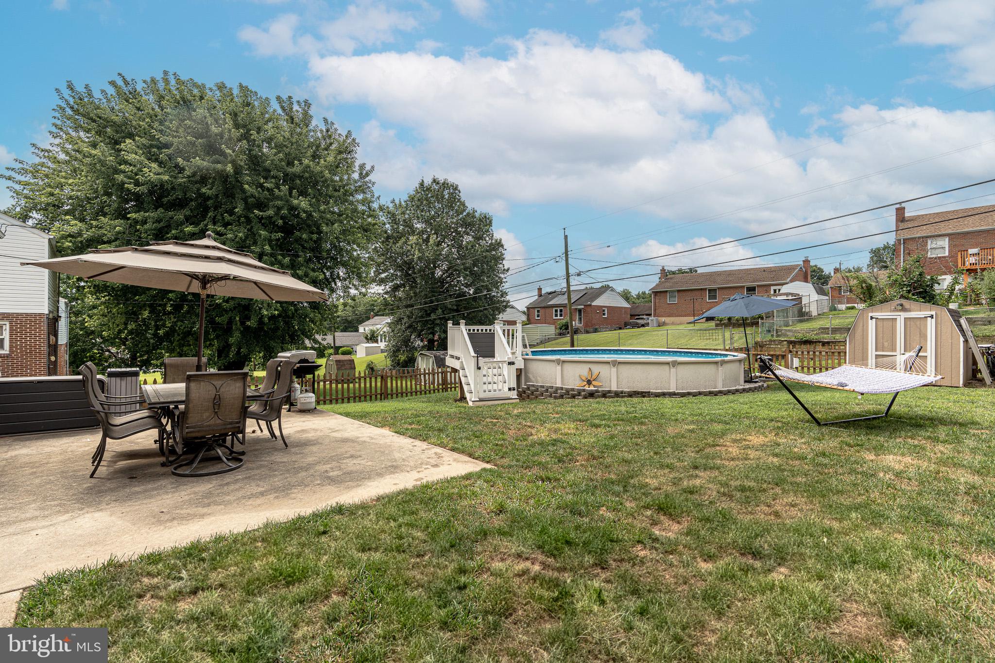 1510 Seling Avenue Rosedale, MD 21237 - Photo 20 of 24 a view of a sitting area with furniture and table under an umbrella