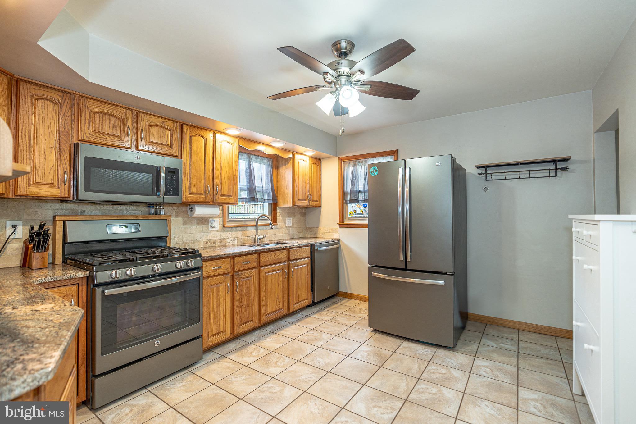1510 Seling Avenue Rosedale, MD 21237 - Photo 5 of 24 a kitchen with stainless steel appliances granite countertop a refrigerator oven a sink and dishwasher