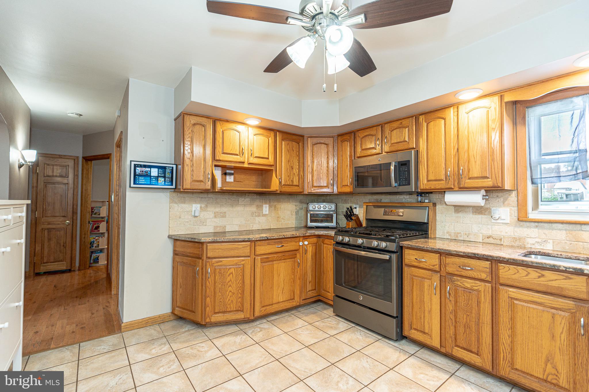 1510 Seling Avenue Rosedale, MD 21237 - Photo 6 of 24 a kitchen with stainless steel appliances granite countertop a stove cabinets and a refrigerator