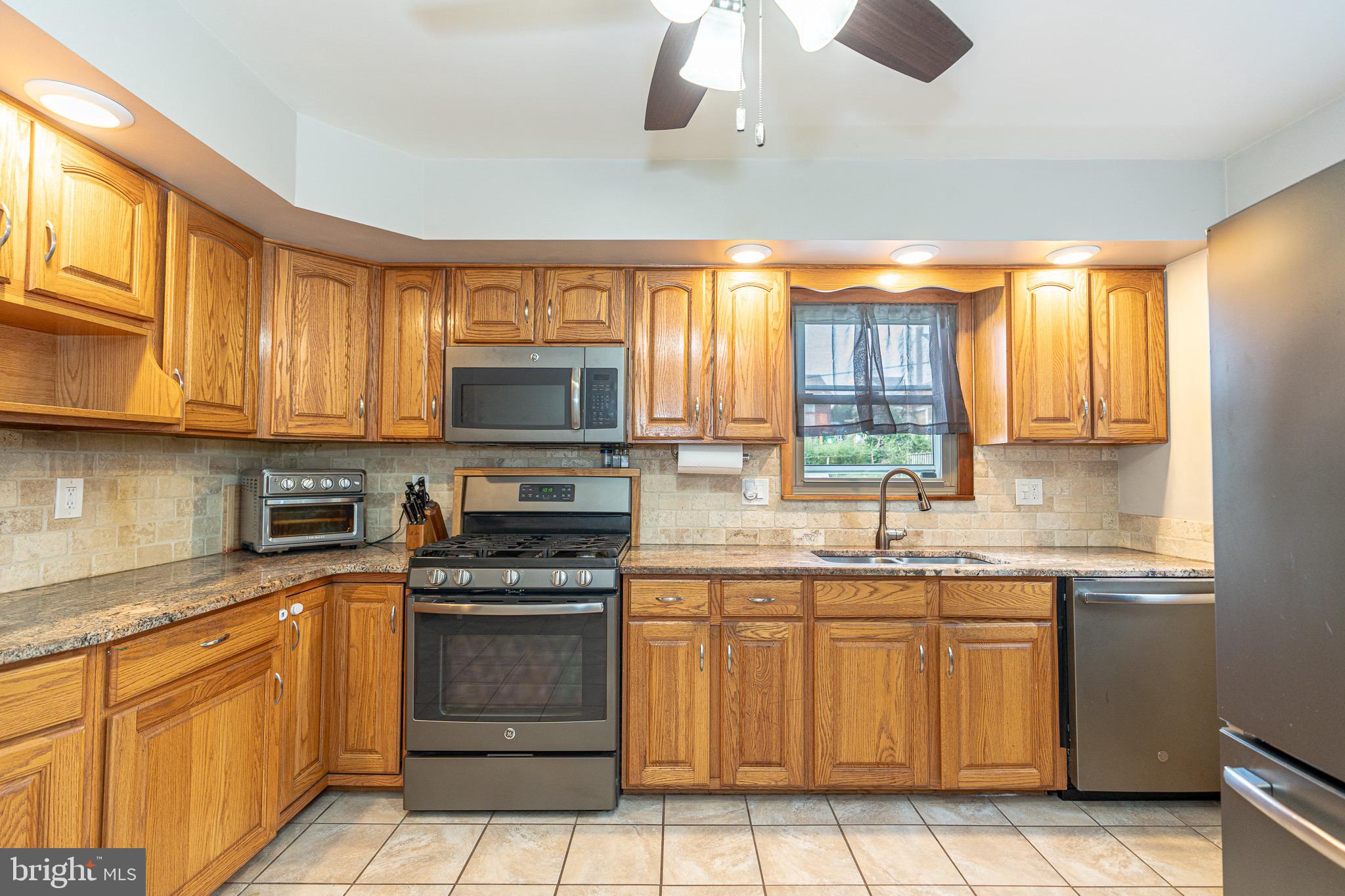 1510 Seling Avenue Rosedale, MD 21237 - Photo 7 of 24 a kitchen with a sink stove and microwave
