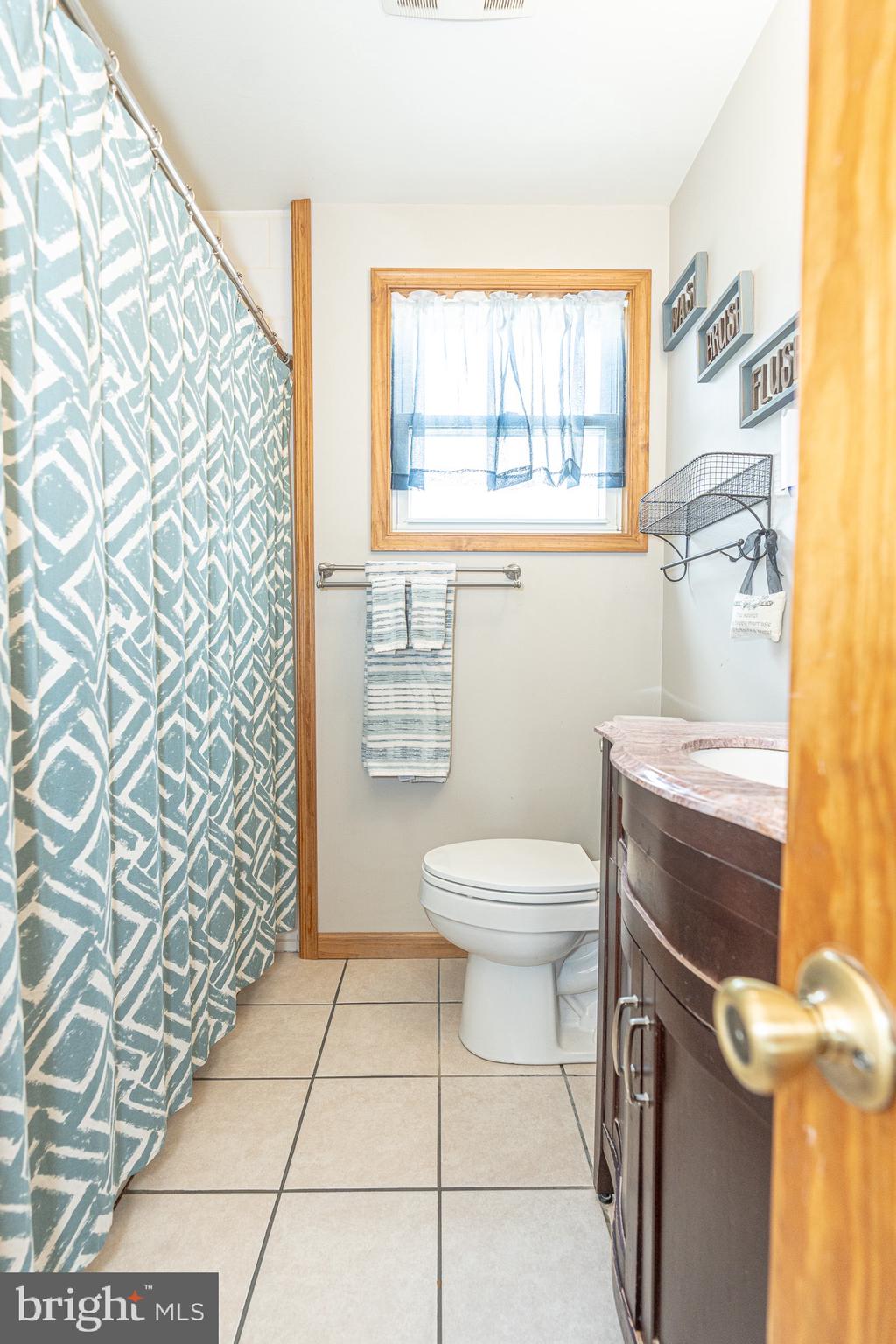 1510 Seling Avenue Rosedale, MD 21237 - Photo 8 of 24 a bathroom with a toilet a sink and a window