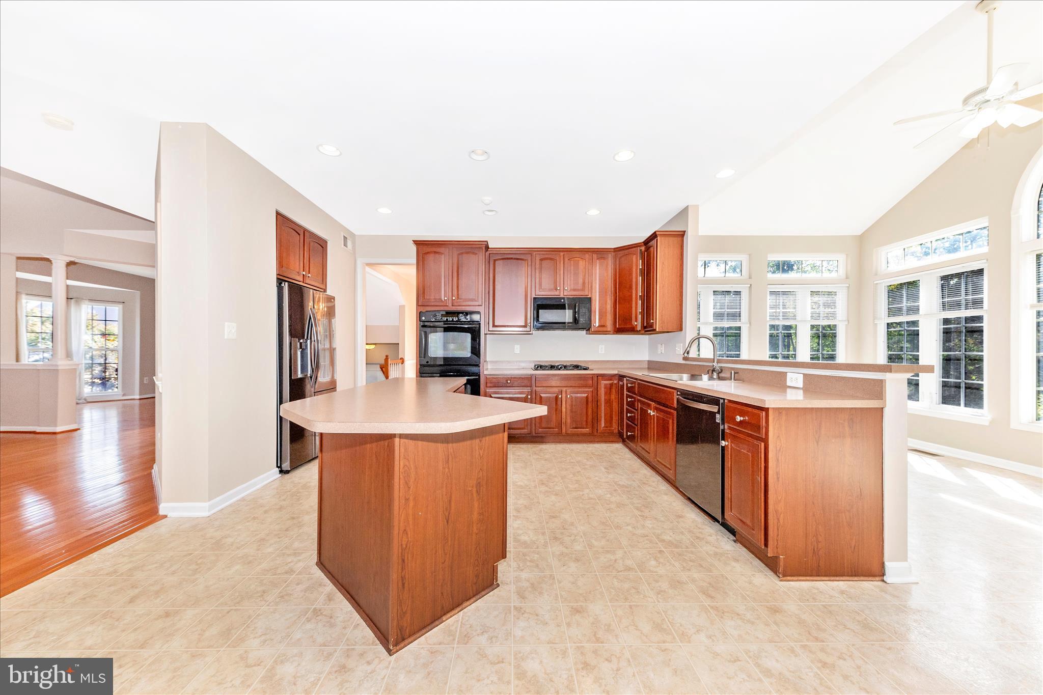 12406 Fallen Timbers Circle Hagerstown, MD 21740 - Photo 12 of 52 a large kitchen with stainless steel appliances kitchen island granite countertop a large counter top stainless steel appliances and cabinets