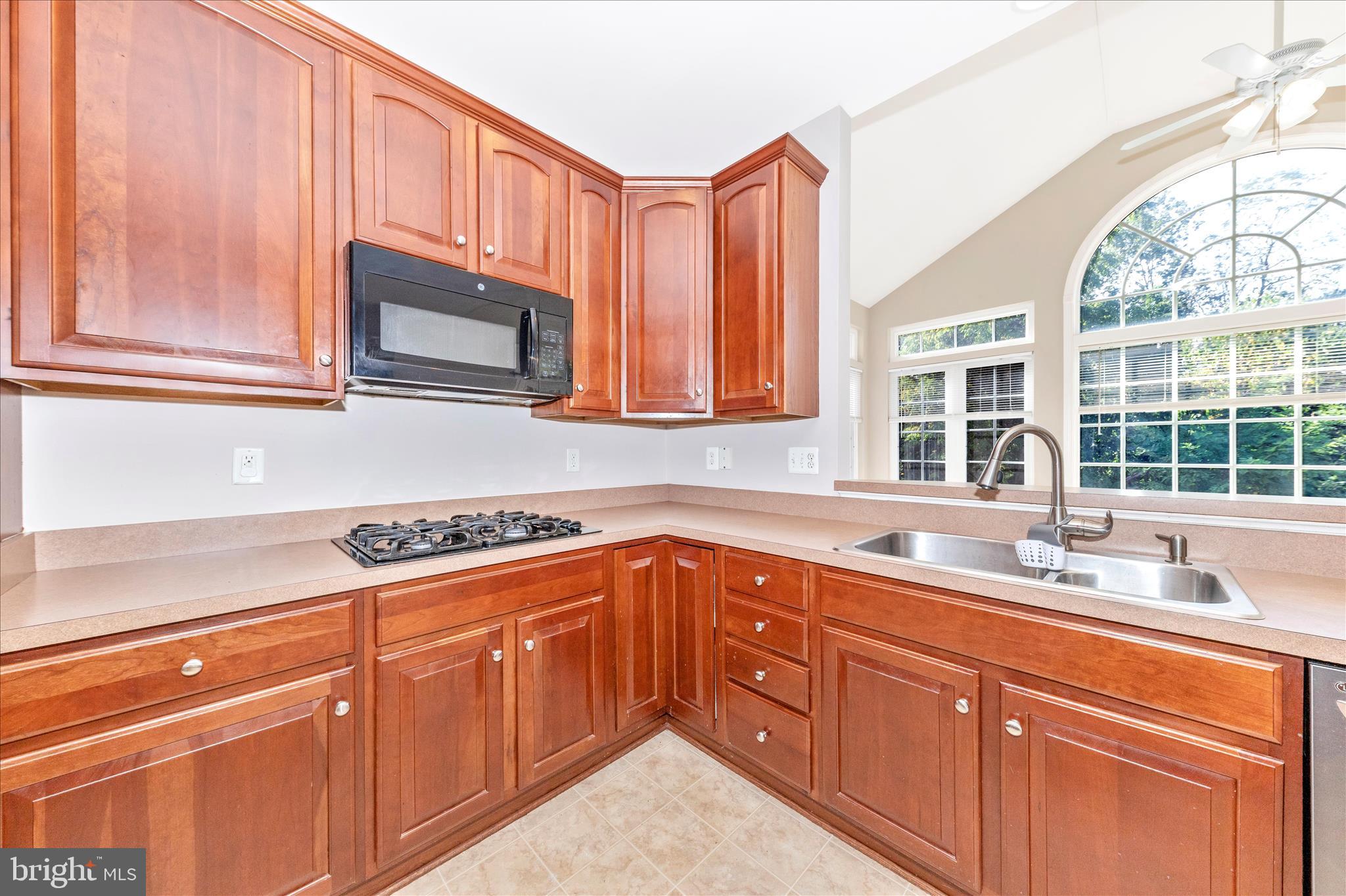 12406 Fallen Timbers Circle Hagerstown, MD 21740 - Photo 14 of 52 a kitchen with stainless steel appliances granite countertop a sink stove and microwave