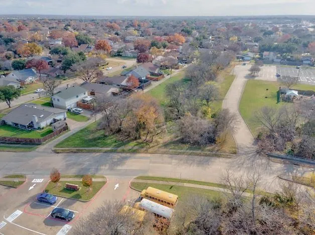 an aerial view of a houses with a swimming pool