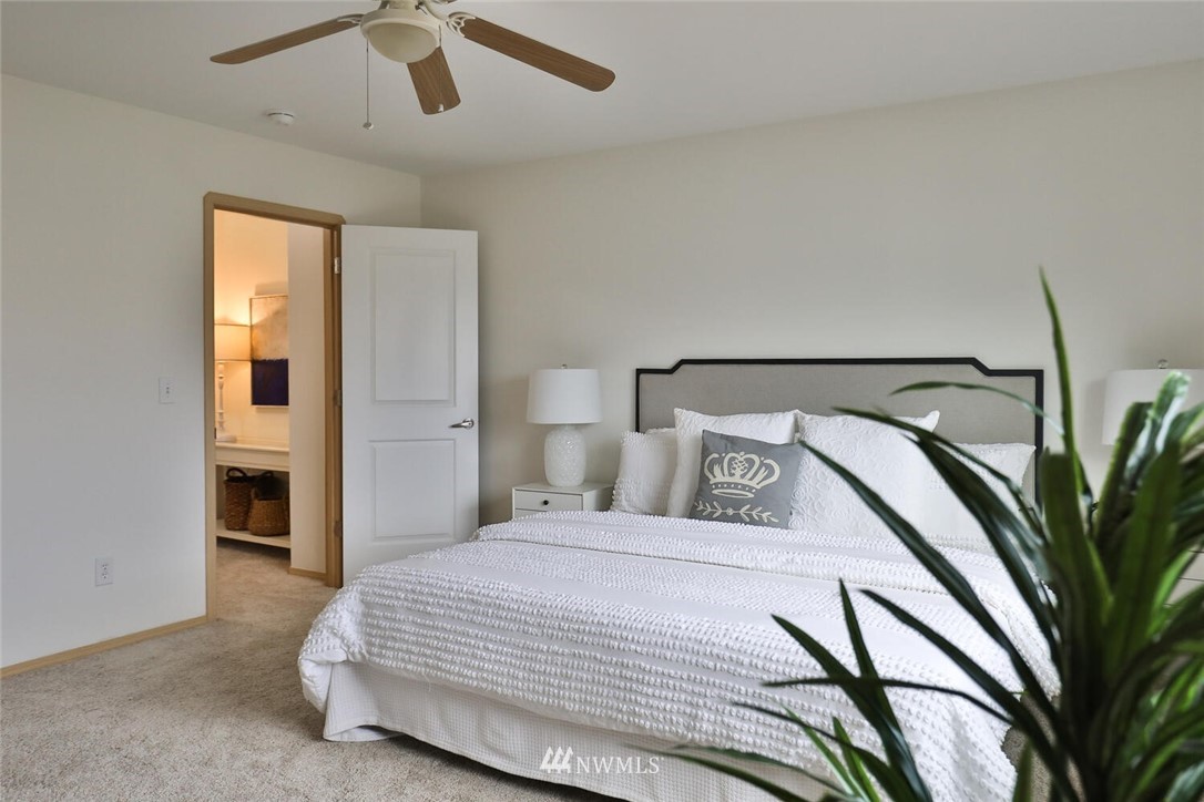 19009 3rd Drive Southeast Bothell, WA 98012 - Photo 10 of 21 a bedroom with a large bed and a chandelier