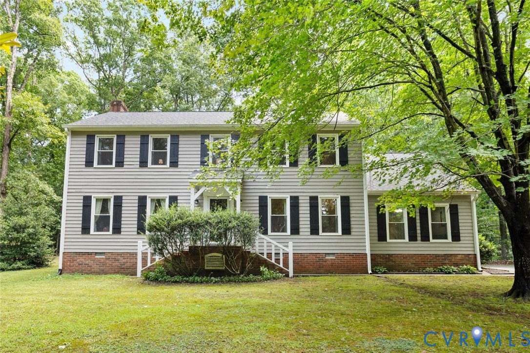 Traditional two-story residence featuring light gr