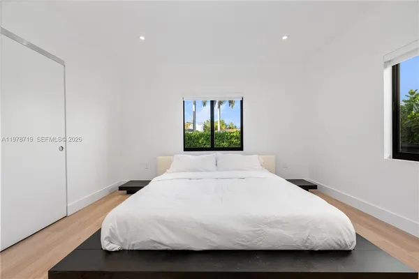 a large bedroom with a large window
