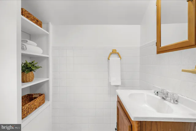 a bathroom with a sink mirror and vanity