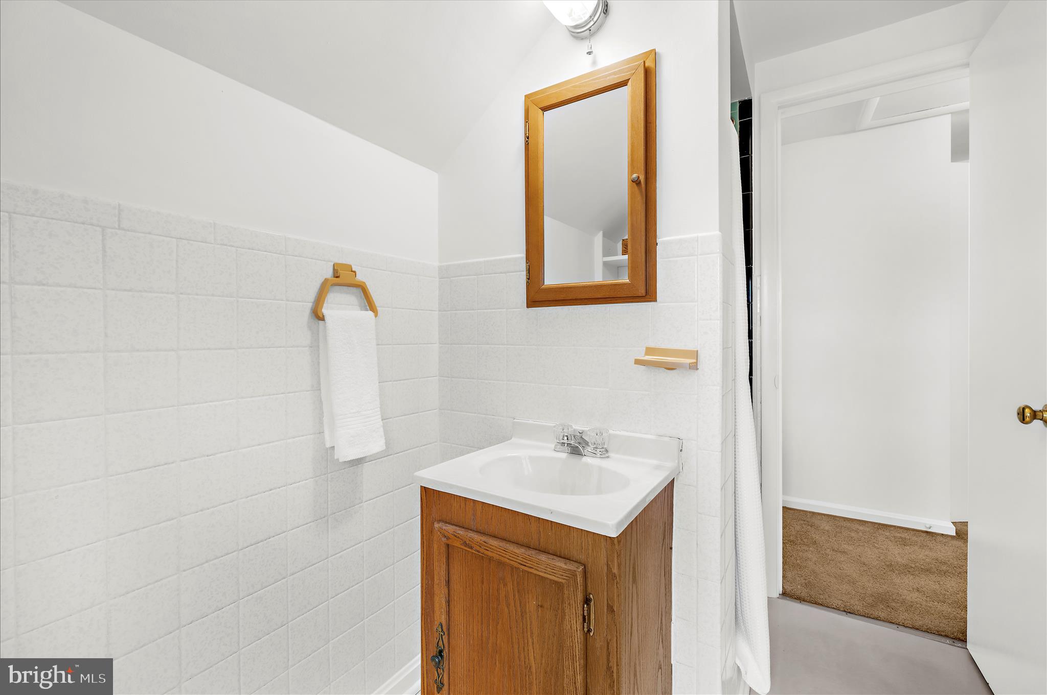 2930 Powder Mill Road Hyattsville, MD 20783 - Photo 28 of 53 a bathroom with a sink mirror and vanity