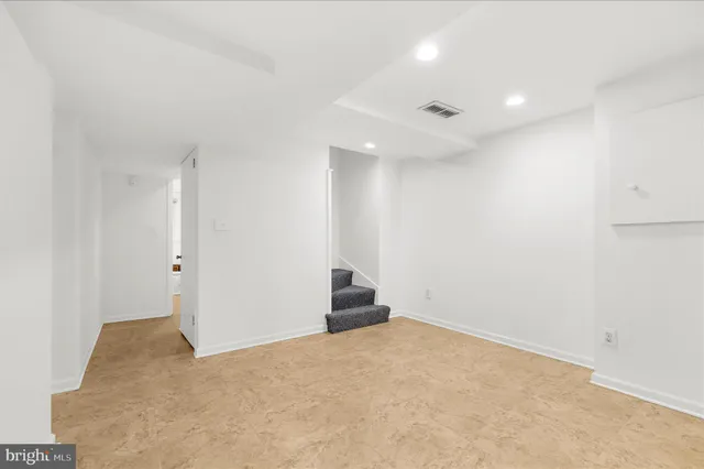 a kitchen with a sink and white cabinets