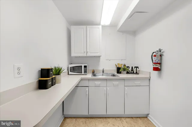 a kitchen with a refrigerator and a sink