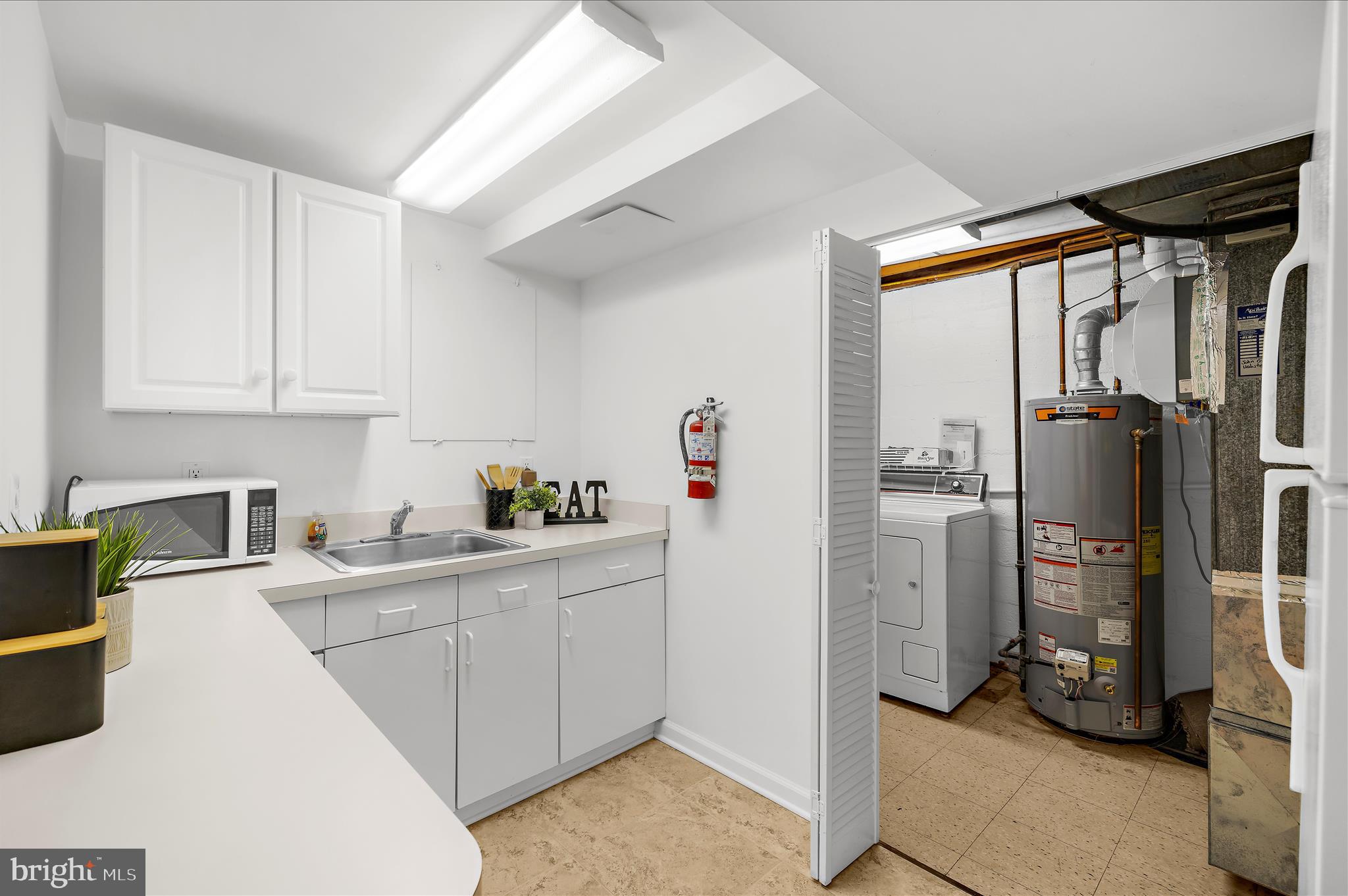 2930 Powder Mill Road Hyattsville, MD 20783 - Photo 39 of 53 a kitchen with a refrigerator and a sink