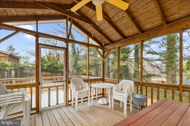 a front view of a house with a yard covered in snow