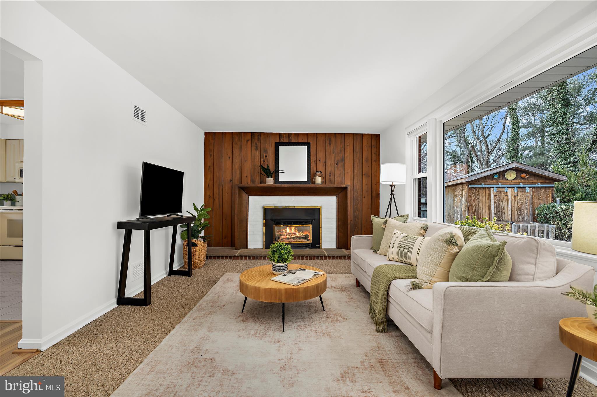 2930 Powder Mill Road Hyattsville, MD 20783 - Photo 5 of 53 a living room with furniture a flat screen tv and a fireplace