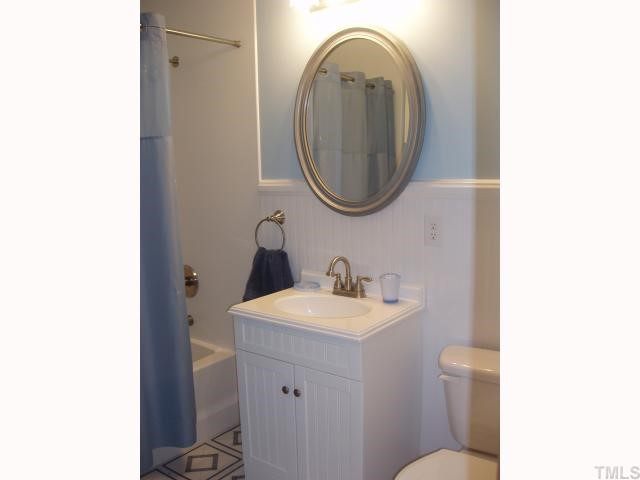 4115 Laurel Ridge Drive Raleigh, NC 27612 - Photo 8 of 12 a bathroom with a sink and a mirror