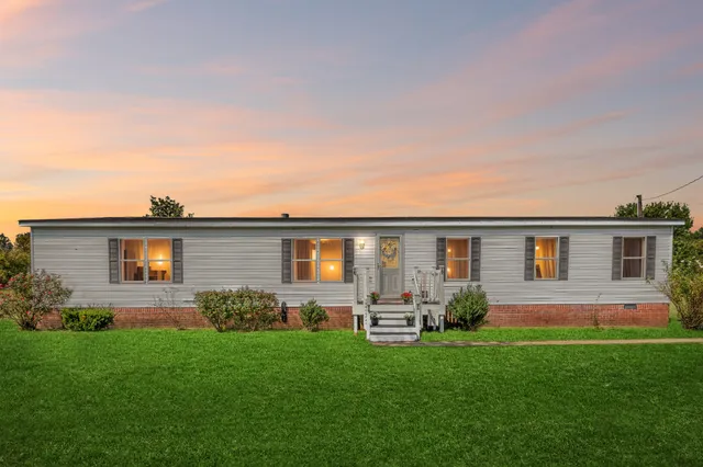 a front view of house with yard and green space