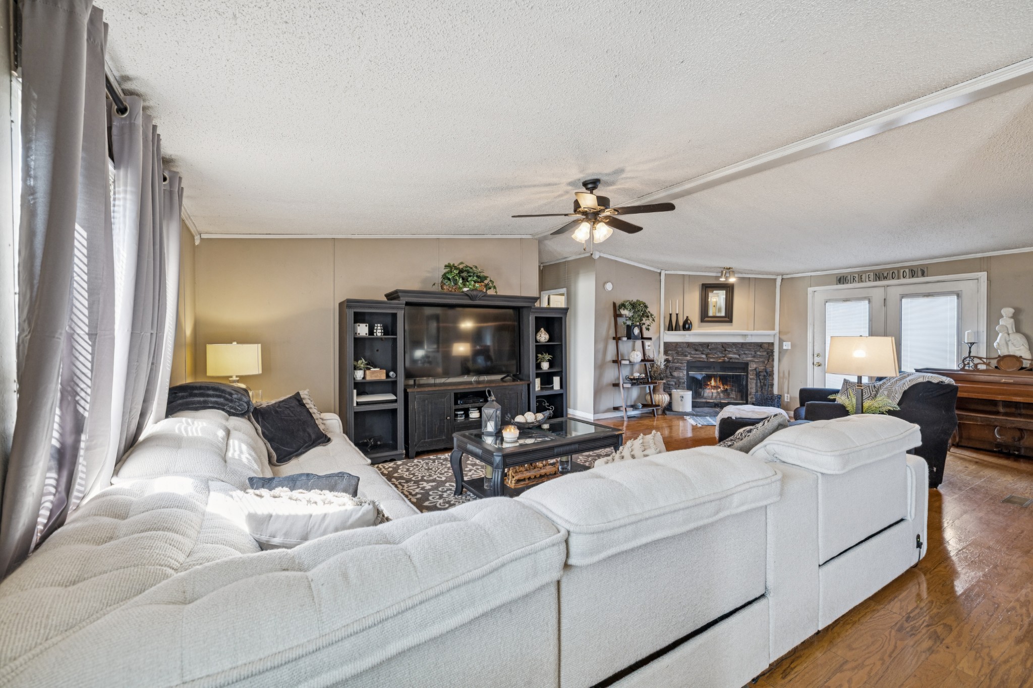 257 Bunker Hill Road Rockvale, TN 37153 - Photo 13 of 38 a living room with furniture a fireplace and a flat screen tv