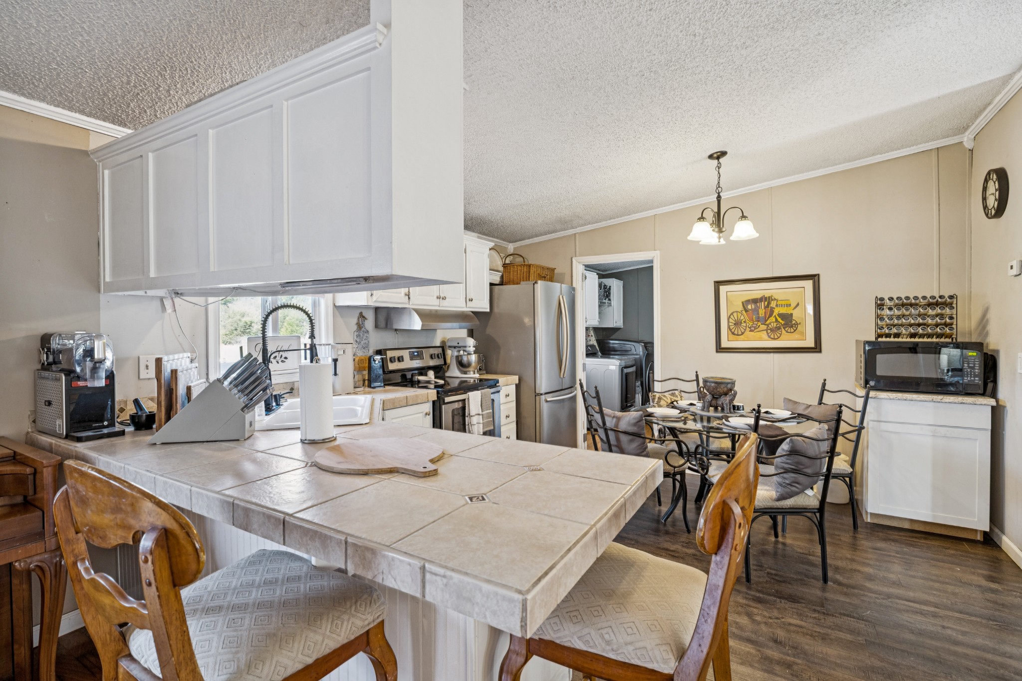 257 Bunker Hill Road Rockvale, TN 37153 - Photo 17 of 38 a kitchen with a dining table chairs and white cabinets