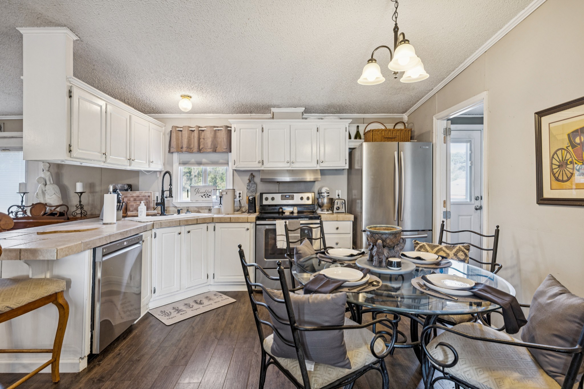 257 Bunker Hill Road Rockvale, TN 37153 - Photo 18 of 38 a kitchen with a dining table chairs and white cabinets
