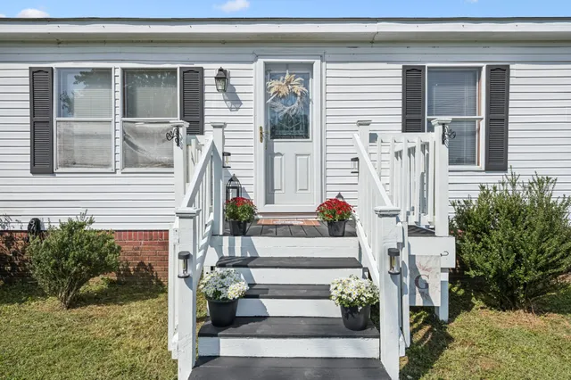 a front view of a house with a garden